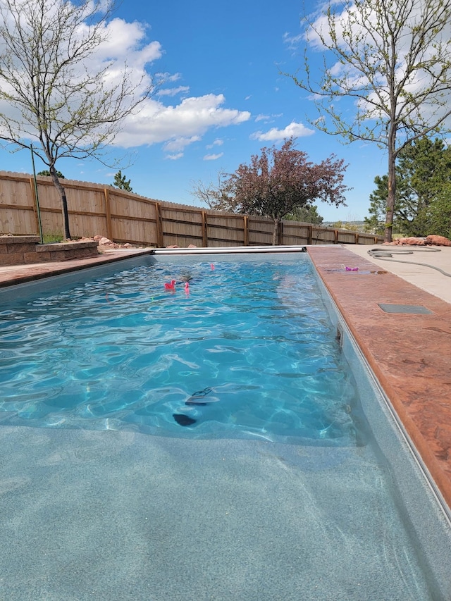 view of swimming pool with a fenced in pool and a fenced backyard