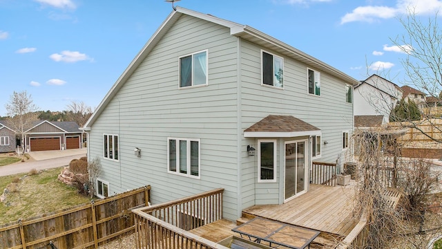 back of property featuring fence and a deck