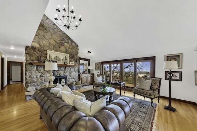 living area featuring baseboards, high vaulted ceiling, a notable chandelier, and wood finished floors