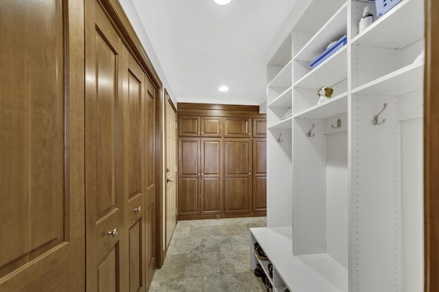mudroom featuring recessed lighting and crown molding