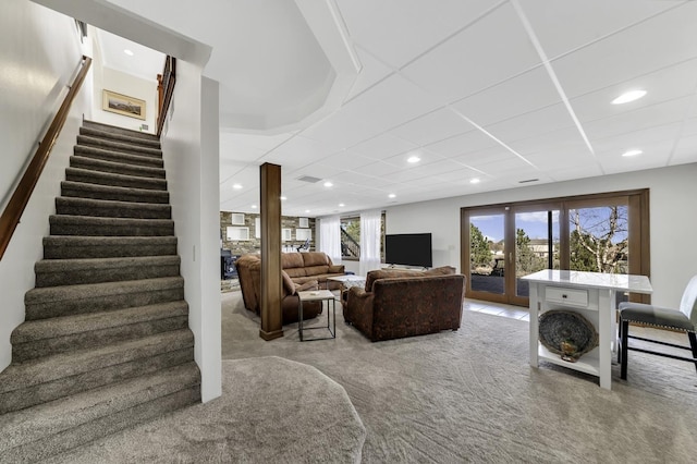 living area featuring recessed lighting, carpet, and stairway