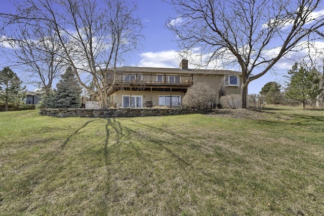 rear view of property featuring a yard, a deck, and a chimney