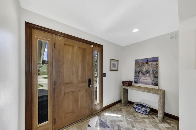entrance foyer with baseboards and visible vents