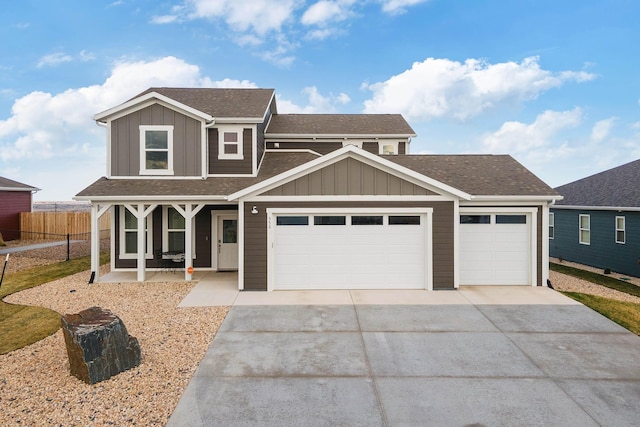 552 Other, Rapid City, SD 57703 - view of front facade featuring concrete driveway, board and batten siding, a garage, fence, and a shingled roof