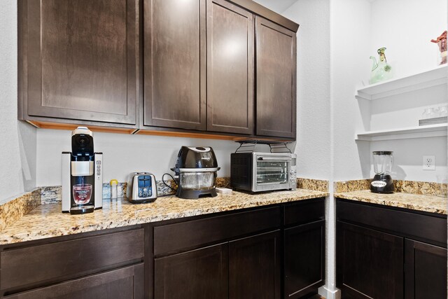 552 Other, Rapid City, SD 57703 - kitchen with dark brown cabinetry, light stone counters, and open shelves