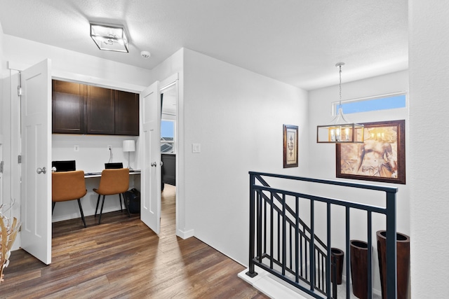 552 Other, Rapid City, SD 57703 - hall featuring a chandelier, a textured ceiling, wood finished floors, and an upstairs landing