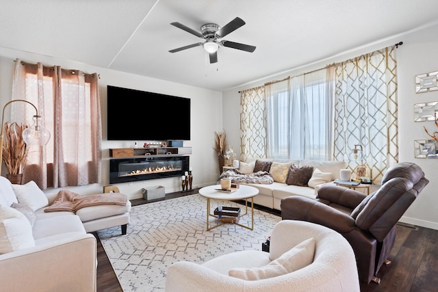 552 Other, Rapid City, SD 57703 - living room featuring a ceiling fan, baseboards, dark wood-style floors, and a glass covered fireplace