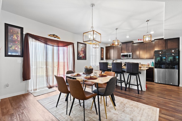 552 Other, Rapid City, SD 57703 - dining area with an inviting chandelier, baseboards, dark wood finished floors, and recessed lighting