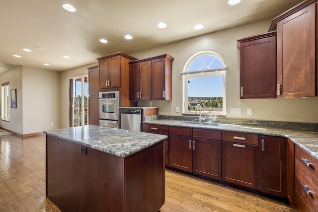 6627 Kennemer Dr, Rapid City, SD 57702 - kitchen with recessed lighting, a center island, dishwasher, a sink, and light wood finished floors