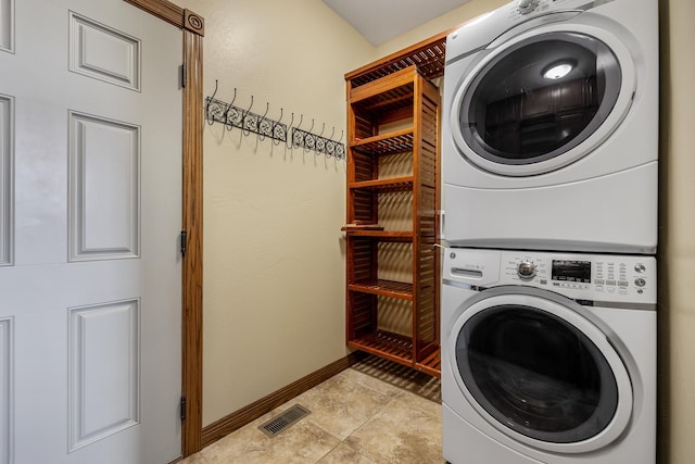 6627 Kennemer Dr, Rapid City, SD 57702 - laundry area featuring baseboards, stacked washer / dryer, laundry area, and visible vents