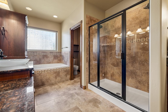 6627 Kennemer Dr, Rapid City, SD 57702 - bathroom featuring vanity, a stall shower, recessed lighting, toilet, and a garden tub