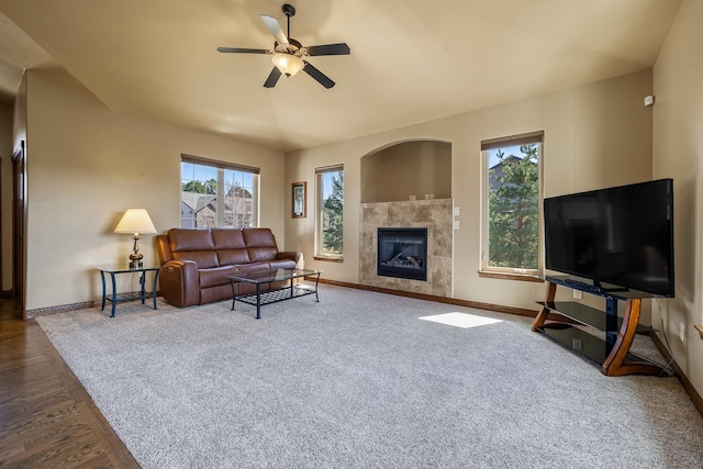 6627 Kennemer Dr, Rapid City, SD 57702 - carpeted living room with wood finished floors, ceiling fan, baseboards, and a fireplace