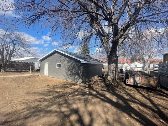 1021 Omaha St, Belle Fourche, SD 57717 - view of side of property featuring fence and an outbuilding