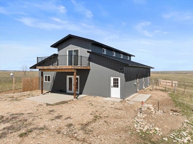 back of property featuring a patio area, french doors, a wooden deck, and fence