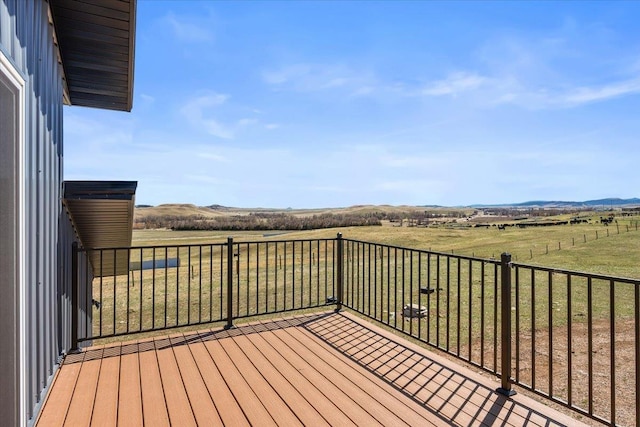 wooden terrace featuring a rural view