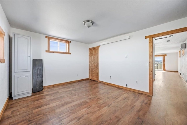 interior space with a wealth of natural light, light wood-style floors, and baseboards