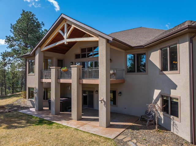 2724 Diamond Oak Pl, Rapid City, SD 57702 - back of property with a patio, a shingled roof, stucco siding, and a balcony