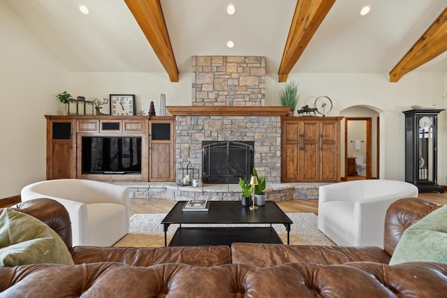 2724 Diamond Oak Pl, Rapid City, SD 57702 - living room with arched walkways, wood finished floors, beamed ceiling, and a fireplace