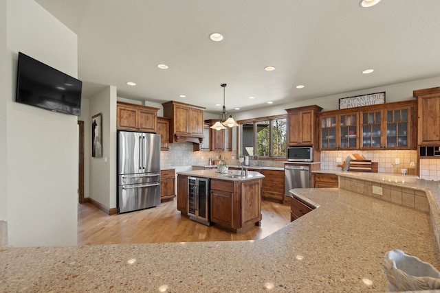 2724 Diamond Oak Pl, Rapid City, SD 57702 - kitchen with brown cabinets, light wood finished floors, beverage cooler, and stainless steel appliances