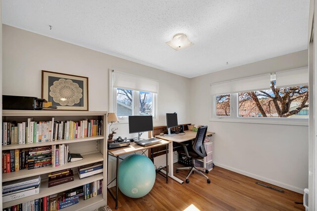 1106 Allen St, Rapid City, SD 57701 - office area featuring a textured ceiling, wood finished floors, baseboards, and visible vents