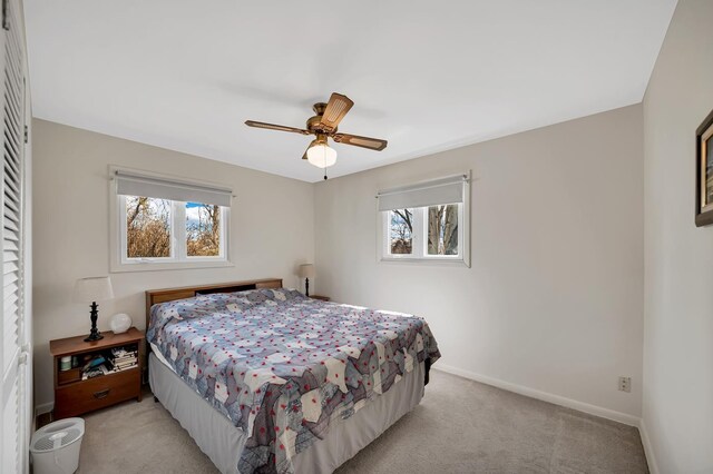 1106 Allen St, Rapid City, SD 57701 - bedroom featuring baseboards, multiple windows, light colored carpet, and a ceiling fan