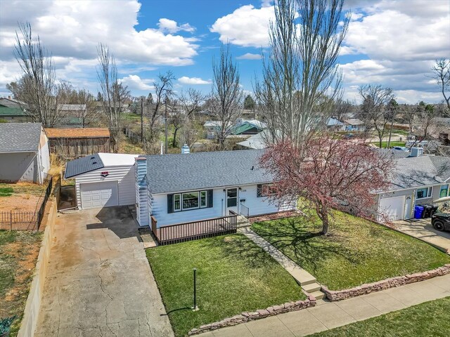 1106 Allen St, Rapid City, SD 57701 - ranch-style house with a garage, fence, concrete driveway, a front lawn, and roof with shingles