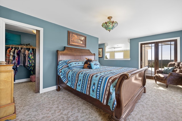 11583 Pay Dirt Pass, Custer, SD 57730 - bedroom featuring a walk in closet, carpet flooring, baseboards, and french doors