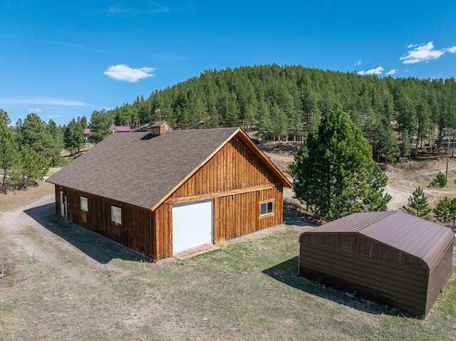 11583 Pay Dirt Pass, Custer, SD 57730 - detached garage with a view of trees