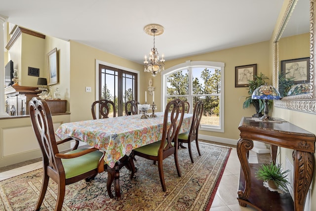 11583 Pay Dirt Pass, Custer, SD 57730 - dining area featuring baseboards, a chandelier, and light tile patterned flooring