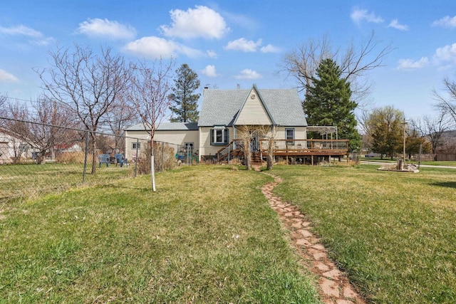 back of house featuring a lawn, a deck, stairs, and a shingled roof