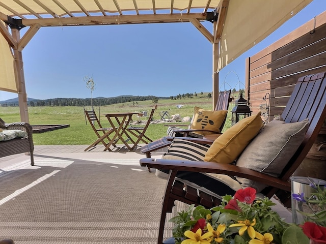 view of patio / terrace with a pergola and a view of countryside