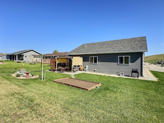 back of house featuring a yard and a patio area