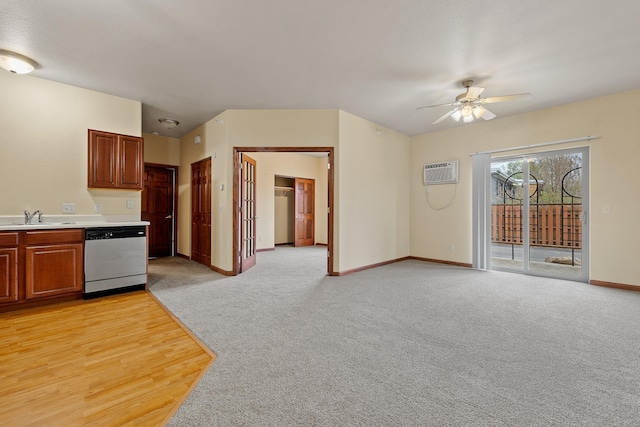 1632 Evergreen Dr, Rapid City, SD 57702 - kitchen with stainless steel dishwasher, a sink, a wall mounted air conditioner, ceiling fan, and light countertops