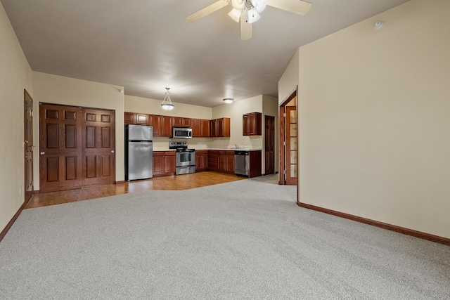 1632 Evergreen Dr, Rapid City, SD 57702 - unfurnished living room with baseboards, a ceiling fan, and light colored carpet