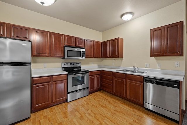 1632 Evergreen Dr, Rapid City, SD 57702 - kitchen featuring light countertops, light wood-type flooring, appliances with stainless steel finishes, and a sink