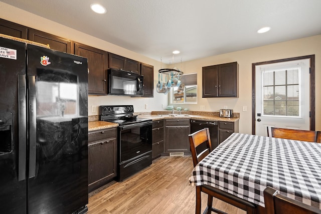 2207 Other, Rapid City, SD 57703 - kitchen with recessed lighting, dark brown cabinets, a sink, light wood-type flooring, and black appliances
