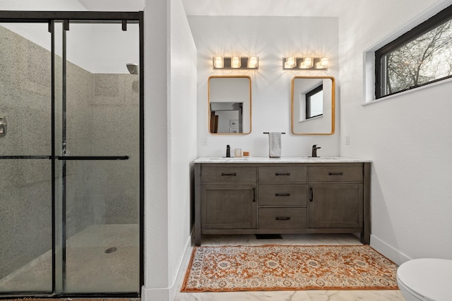 3818 W Main St, Rapid City, SD 57702 - bathroom with a sink, double vanity, toilet, a stall shower, and baseboards