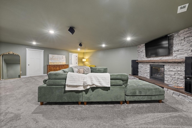 3818 W Main St, Rapid City, SD 57702 - carpeted living room featuring recessed lighting, arched walkways, visible vents, and a stone fireplace