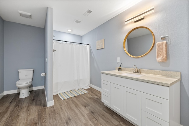 3818 W Main St, Rapid City, SD 57702 - bathroom featuring wood finished floors, visible vents, and toilet