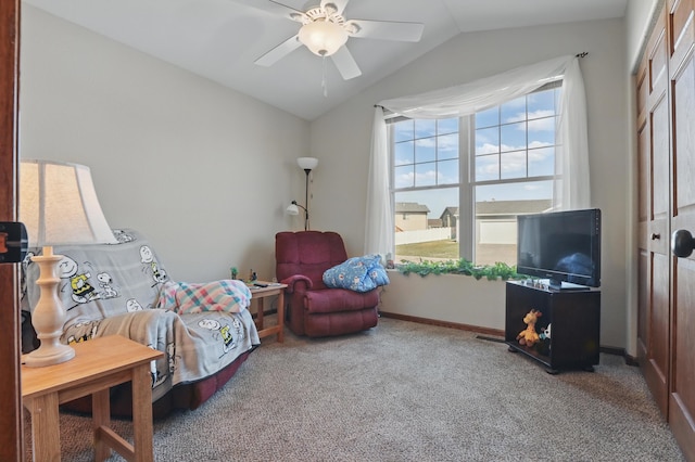 living area featuring baseboards, vaulted ceiling, carpet flooring, and a ceiling fan