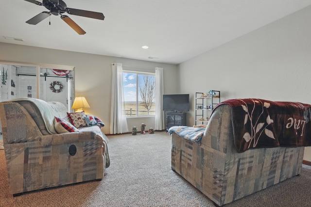 carpeted living room featuring ceiling fan, visible vents, and recessed lighting