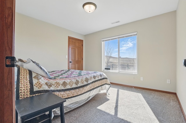 carpeted bedroom with visible vents and baseboards