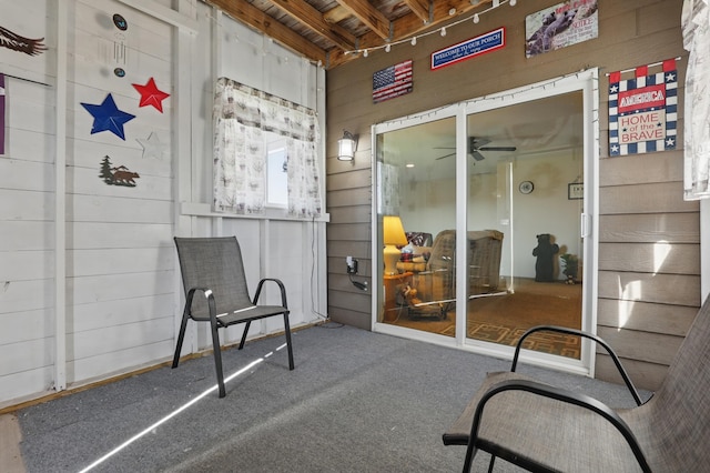 sunroom / solarium with a ceiling fan