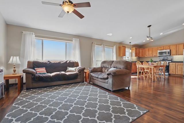 living room featuring vaulted ceiling, dark wood-style floors, and ceiling fan