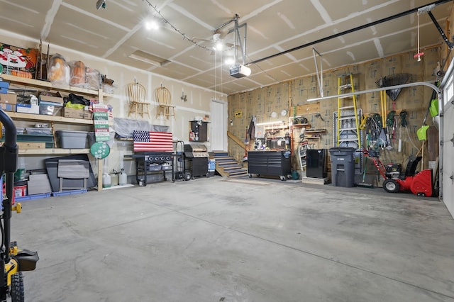 garage featuring a workshop area and a garage door opener