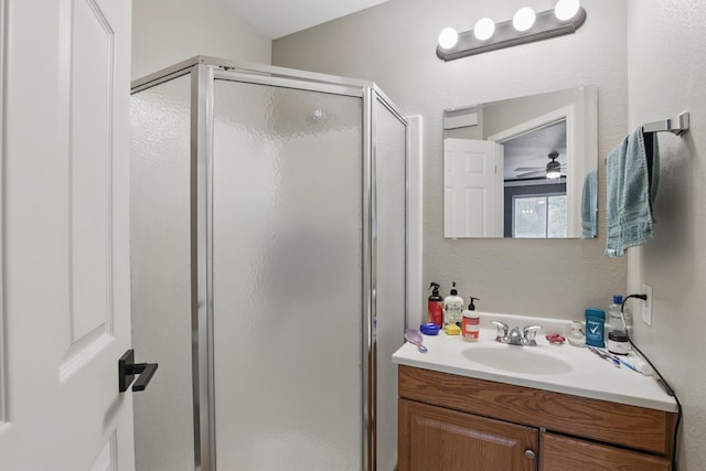 12634 Robins Roost Rd, Hill City, SD 57745 - bathroom featuring ceiling fan, vanity, and a stall shower