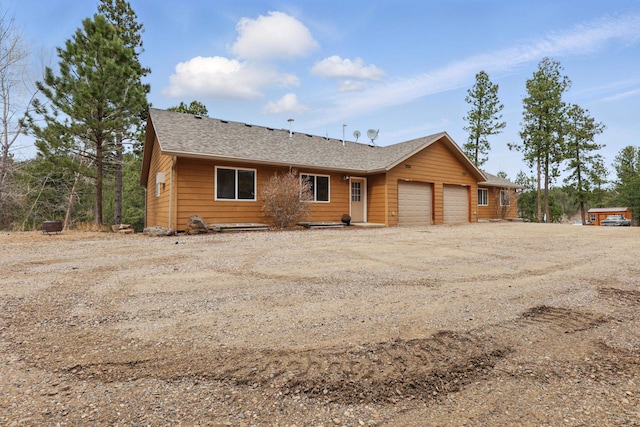 12634 Robins Roost Rd, Hill City, SD 57745 - view of front of property featuring an attached garage, driveway, and a shingled roof
