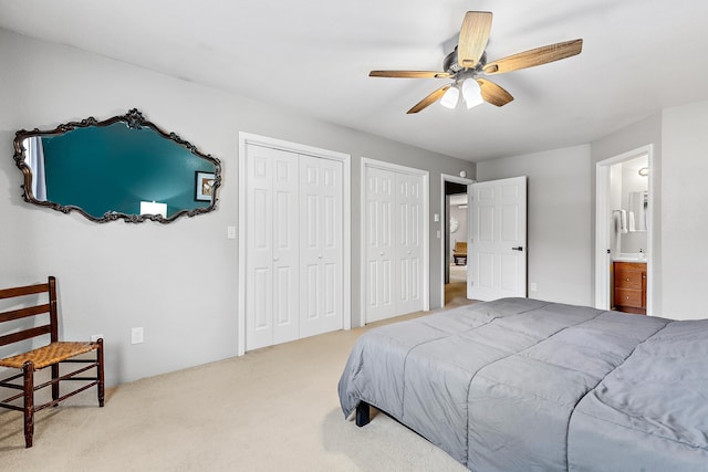 12634 Robins Roost Rd, Hill City, SD 57745 - carpeted bedroom featuring multiple closets, ensuite bathroom, and ceiling fan