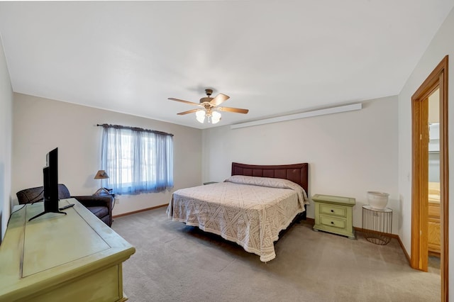 carpeted bedroom with a ceiling fan and baseboards