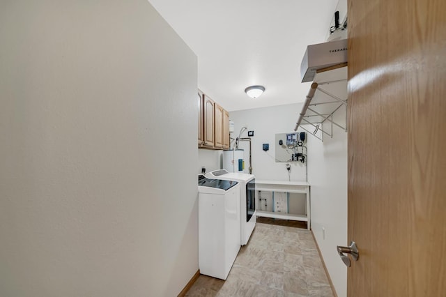 laundry area with washing machine and dryer, baseboards, water heater, and cabinet space